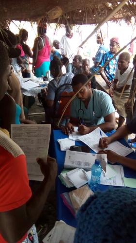 Patients filling out paperwork in mobile clinic