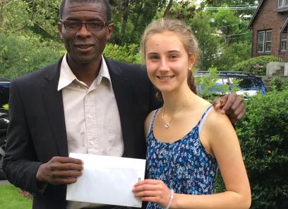 Daisy handing check to dr. pierre