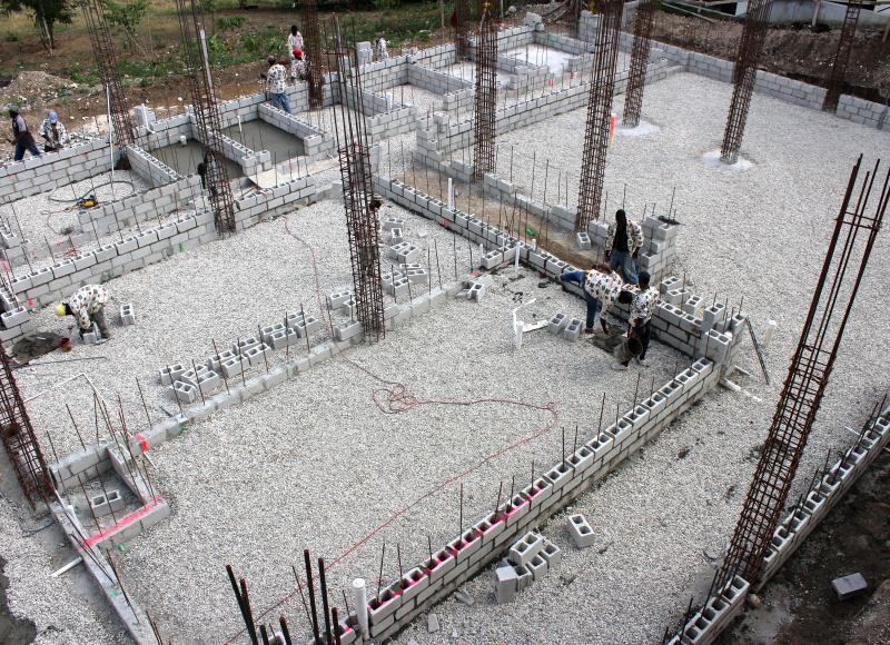 Grey concrete foundation of the SBH surgical center. Rebar sticks out from the foundation at various points.