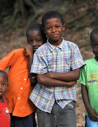 Group of four young children smiling